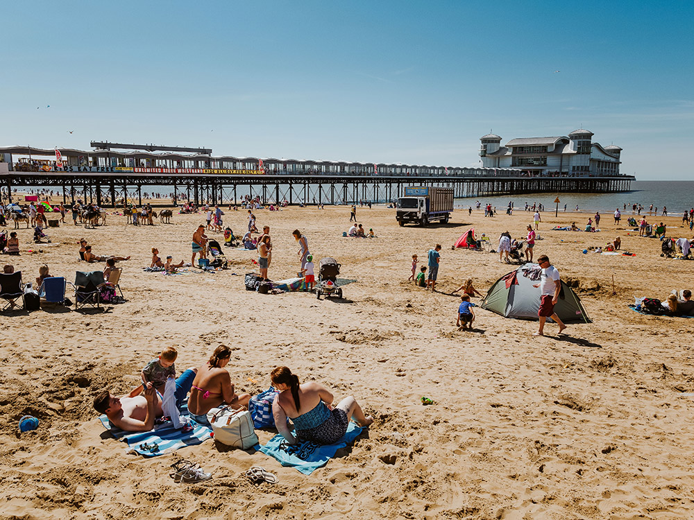 Holidaymakers on the beach at the Grand Pier in Weston Super Mare